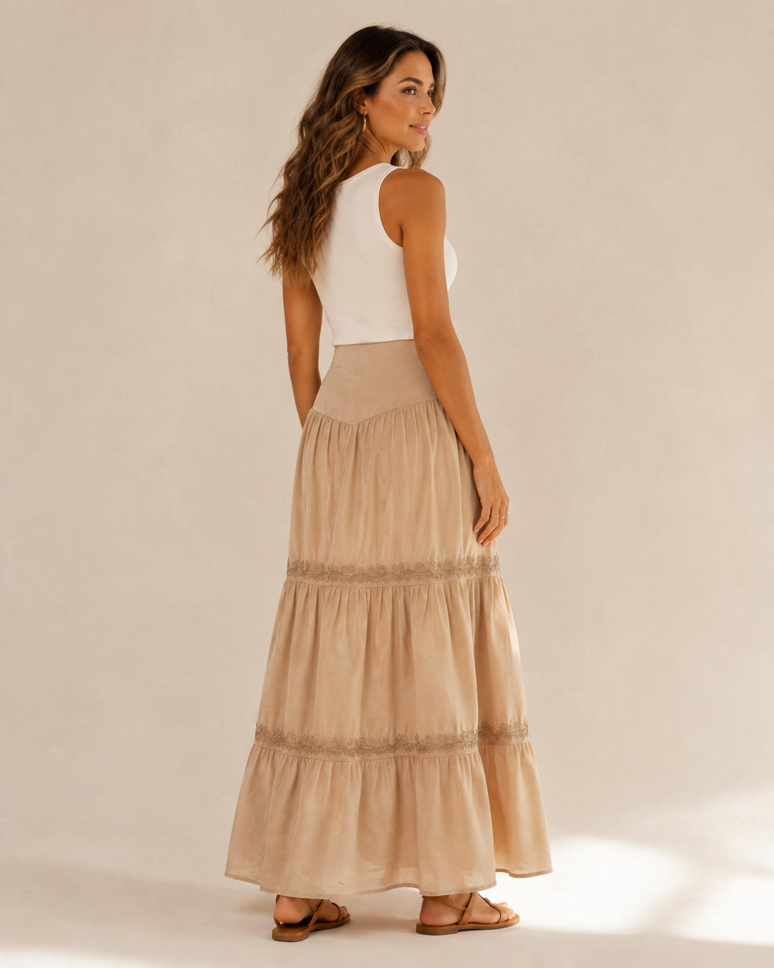 Model wearing the Golden Hour Tiered Maxi Skirt from a back three-quarter view